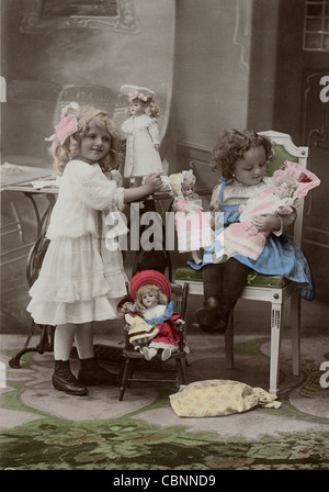 Two Little Girls Playing with Dolls Stock Photo