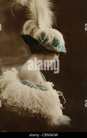 Jazz Age Beauty in Feathered Hat & Frilly Cape Stock Photo