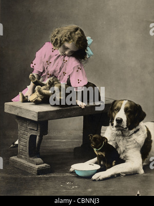 Little Girl with Teddy Bear & Three Dogs Stock Photo