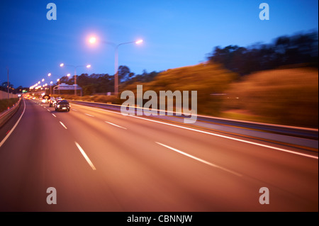 Freeway traffic at dusk Stock Photo