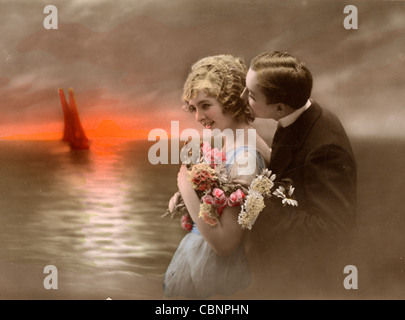 Romantic Lovers at Sunset by the Sea Stock Photo