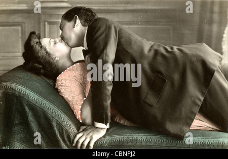 Passionate Couple Kissing on Daybed Stock Photo