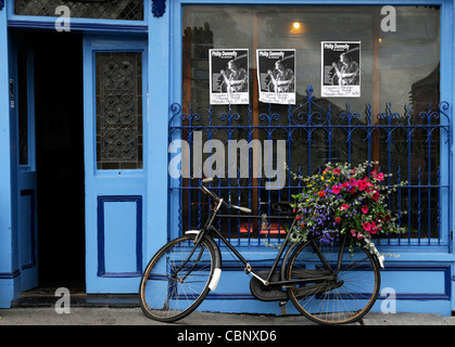 frontal front view tynans bridge house bar pub licensed premises kilkenny ireland blue attraction bike bicycle flower basket Stock Photo