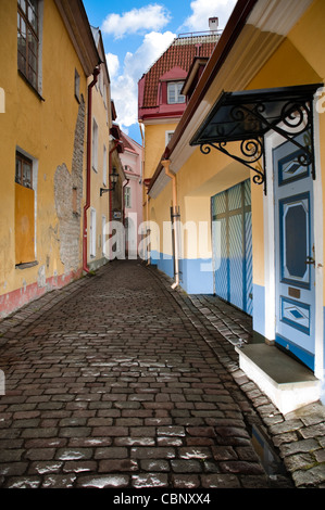 narrow cosy street in center of old european town. Blue cloudy sky in background. Tallin, Estonia, Europe. Stock Photo