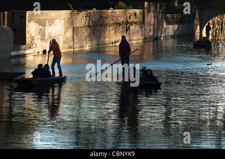 Silhouettes of punters of river Cam, Cambridge. Stock Photo