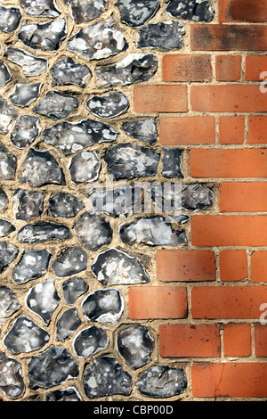 Flint and red brick wall of Saint Mary's Church, The Avenue, Worcester Park Surrey England UK Stock Photo