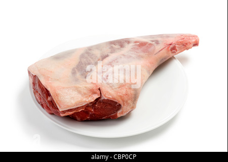 a raw leg of lamb isolated against a white background Stock Photo