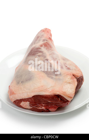 a raw leg of lamb isolated against a white background Stock Photo