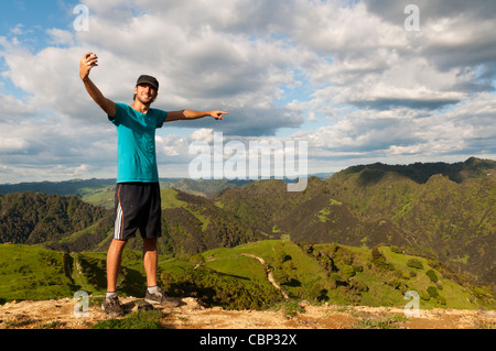 Two young backpackers taking picture with cameras, Blue duck lodge, Whakahoro, Ruapehu District, New Zealand Stock Photo
