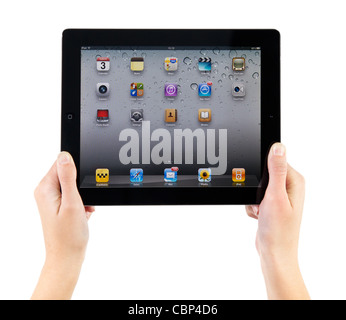 Woman hands holding Apple iPad2 with homepage on a screen. Stock Photo