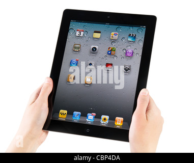 Woman hands holding Apple iPad2 with homepage on a screen. Isolated on white. Stock Photo