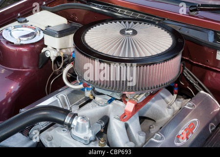 Circular air filter cleaner in the engine bay of a modified custom car Stock Photo