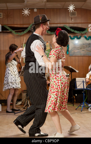 People - a couple -  swing dancing Lindy hopping and jiving to retro 40s 50s music at a club, UK Stock Photo