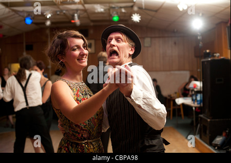 People swing dancing having fun Lindy hopping and jiving to retro 40s 50s music at a club, UK Stock Photo