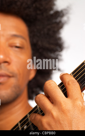 An afro american musician performing on his guitar Stock Photo