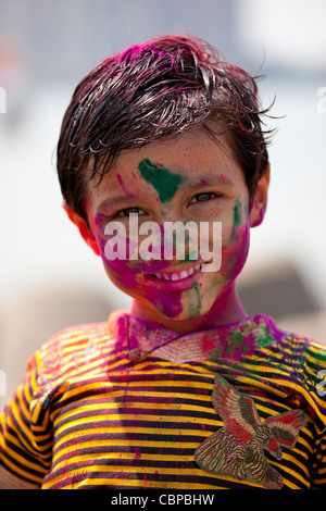 Indian boy celebrating Hindu Holi festival of colours with powder paints in Mumbai, India