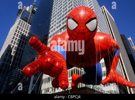 Thanksgiving Day parade. Spiderman inflatable balloon and New York City skyscrapers. Macy's parade in New York, USA. Closeup or close up view. Stock Photo