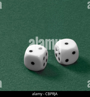 gambling theme with two dice on green felt Stock Photo