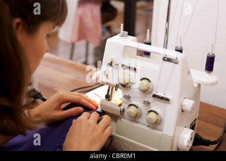 Woman using sewing machine. Stock Photo