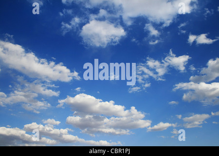 vertical image of blue sky with puffy white clouds Stock Photo