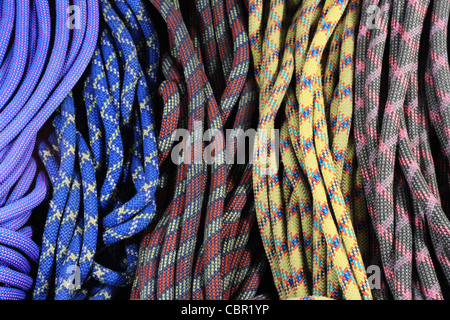 multi-colored old used rock climbing ropes in bundles Stock Photo