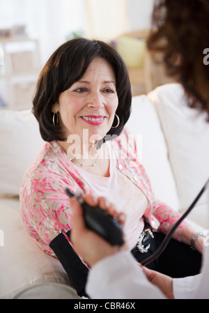 Doctor taking patient's blood pressure Stock Photo