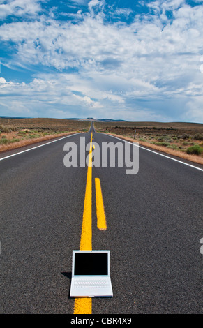 Abstract Information highway with computer in middle of deserted road with internet WIFI access in Oregon Stock Photo