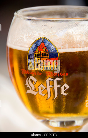 Vertical close up of a Leffe blond beer in a traditional goblet shaped glass. Stock Photo