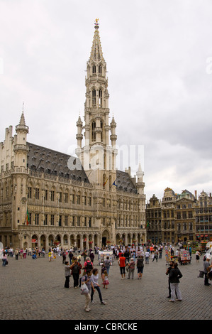 Vertical wide angle view of the amazing Gothic architecture of Brussels Town Hall in a crowded Grand Place. Stock Photo