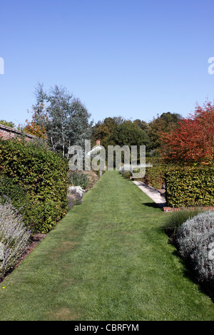 COLOURFUL AUTUMN FLOWER BEDS WITHIN THE WALLED GARDEN AT MARKS HALL IN ESSEX. Stock Photo