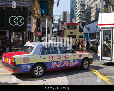 dh  MONG KOK HONG KONG Red Taxi with calligraphy advert in crowded traffic busy street people Stock Photo