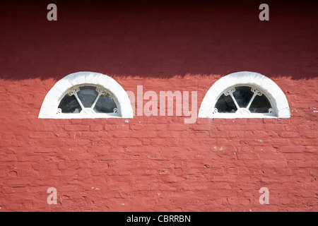 Details with two small windows of a typical red painted farm on the Wadden island Romo, Denmark Stock Photo