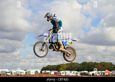 a motocross rider jumps high into the air Stock Photo