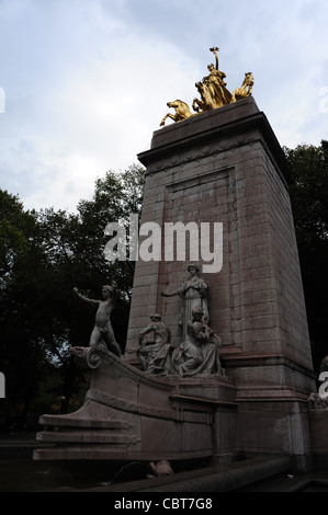 Grey sky autumn trees portrait ship's prow, gilded Columbia Triumphant, front Maine Monument, Central Park South, New York Stock Photo