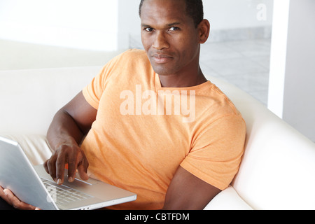 African American man typing on laptop Stock Photo