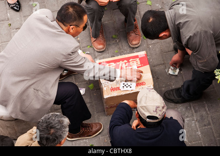 Chinese men playing cards in a street of Shanghai (China) Stock Photo