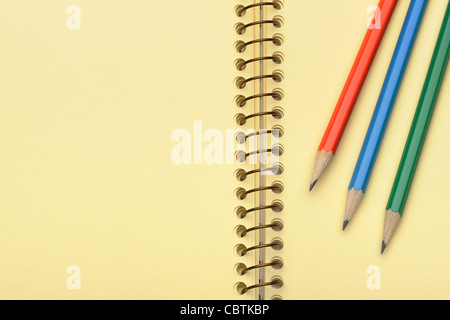 Notebook yellow paper and set pencil. Photo closeup Stock Photo