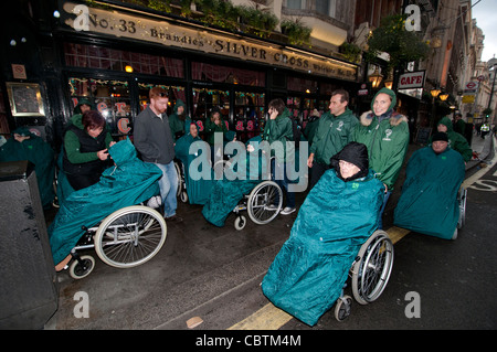 Group of older people on an outing in the rain in London Stock Photo