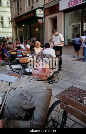 Puppet in human shape sitting at a restaurant table waiting to be served. Karlovi Vari - Karlsbad, Czech Republic Stock Photo