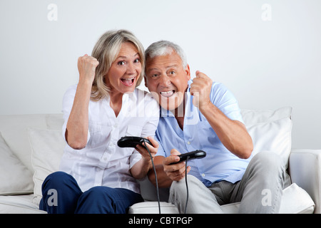 Senior couple having great time playing video game together Stock Photo
