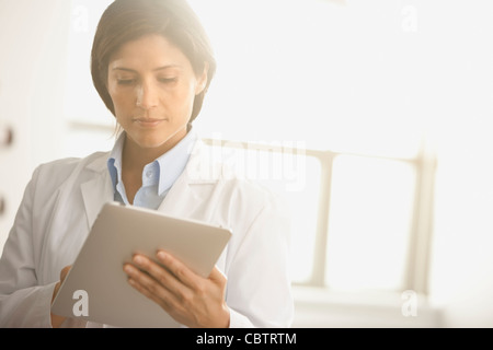 Hispanic doctor using digital tablet Stock Photo