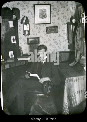 Circa 1900 view of a man in his Victorian parlor or study. Stock Photo