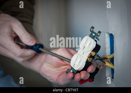 Electrician wiring an electrical receptacle wall socket Stock Photo - Alamy