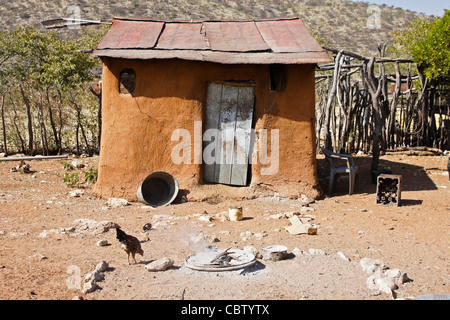 Family home with sacred fire in a Herero village, Damaraland, Namibia Stock Photo