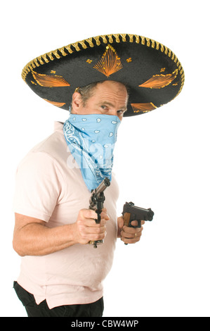 middle age senior tourist male wearing Mexican sombrero Mariachi hat cowboy bandana handgun pistols Stock Photo