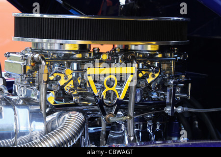 Dual Chromed carburetors connected with V8 symbol linkage. Stock Photo