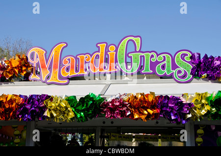 Mardi Gras sign surrounded by brightly colored ribbon bows Stock Photo
