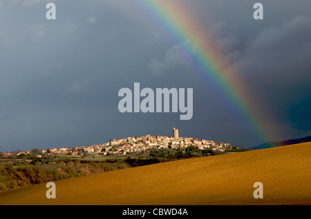 Rainbow over the landscape and village of Montpeyroux, Auvergne, France Stock Photo