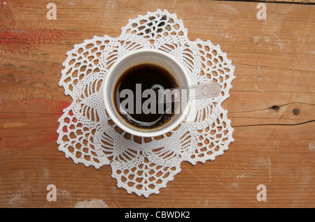 Disposable coffee cup on a place mat. Stock Photo