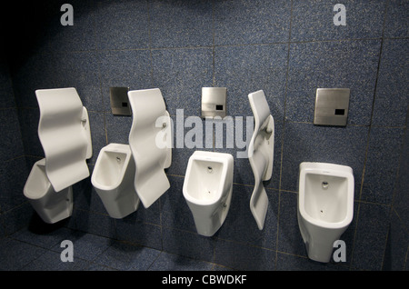 Urinals in gents public toilets. Stock Photo